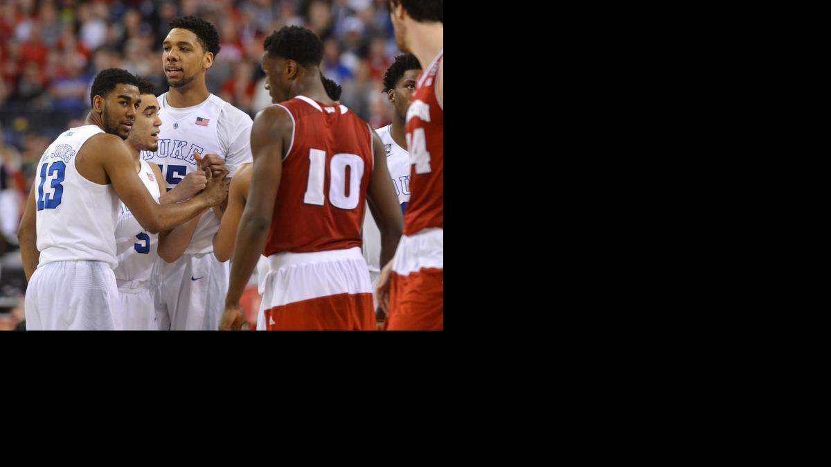 
Duke's Matt Jones (13), Duke's Tyus Jones (5) and Duke's Jahlil Okafor (15) talk as they look at Wisconsin's Nigel Hayes (10) during the second half of Duke's game against Wisconsin in the 2015 Division I Men's Basketball Championship game at Lucas Oil Stadium in Indianapolis, Ind., Monday, April 6, 2015. 
