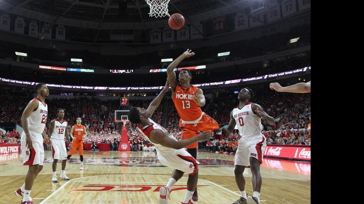 
Virginia Tech’s Ahmed Hill, 13 is called for the foul as he charges into N.C. State’s Lennard Freeman 
 in the first half during N.C. State’s 69-53 victory over Virginia Tech on Feb. 21 at PNC Arena in Raleigh.
