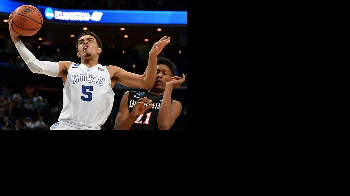 
Duke guard Tyus Jones (5) goes in to score over San Diego State forward Malik Pope (21) in the second half of play. Duke beat San Diego State University 68-49 at the Time-Warner Cable Arena in Charlotte, Sunday, March 22, 2015. The Blue Devils will advance to the NCAA Sweet Sixteen in Houston.
