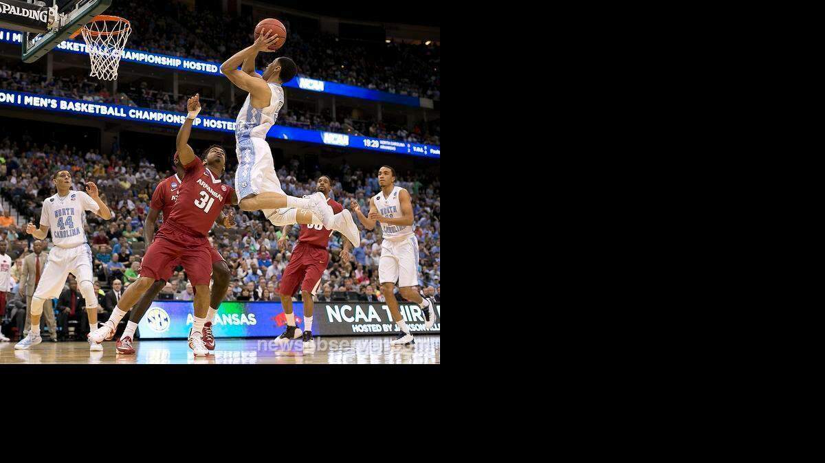 
North Carolina’s Marcus Paige (5) drives to the basket against Arkansas’ Anton Beard (31) during the first half in the third round of the NCAA Tournament on Saturday, March 21, 2015 at the Jacksonville Veterans Memorial Arena in Jacksonville, Fla. Paige led North Carolina with 22 points in their 87-78 victory.
