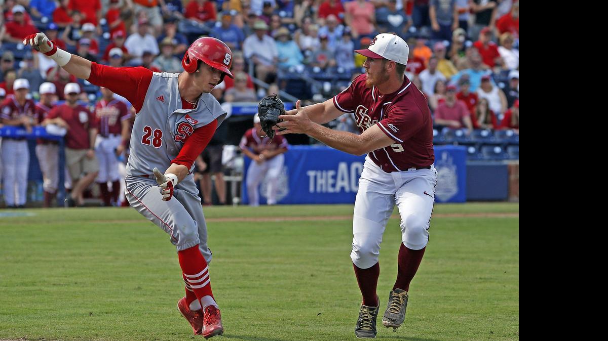 
Florida State’s Billy Strode reaches to tag N.C. State’s Josh McLain for the final out  Sunday in Durham. 
