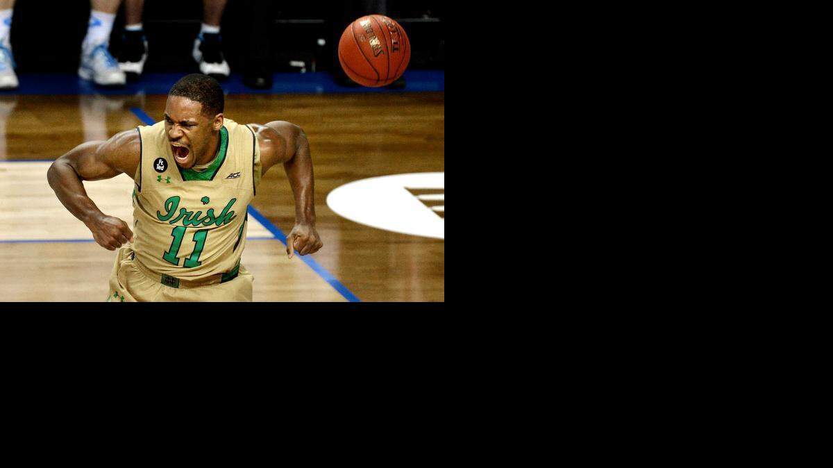 
Notre Dame guard Demetrius Jackson  lets out a shout after a first-half dunk against the Tar Heels. The Fighting Irish beat North Carolina 90-82 Saturday night to win the ACC Championship. 
