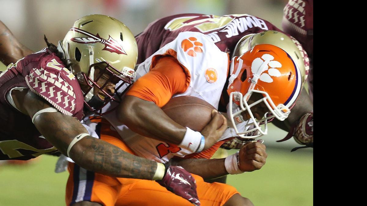 
Florida State linebacker Terrance Smith, left, sacks Clemson quarterback Deshaun Watson on Sept. 20, 2014. The two Atlantic Division teams combined for 125 of 158 championship votes in the ACC preseason poll, with Clemson the overwhelming pick to win the conference.
