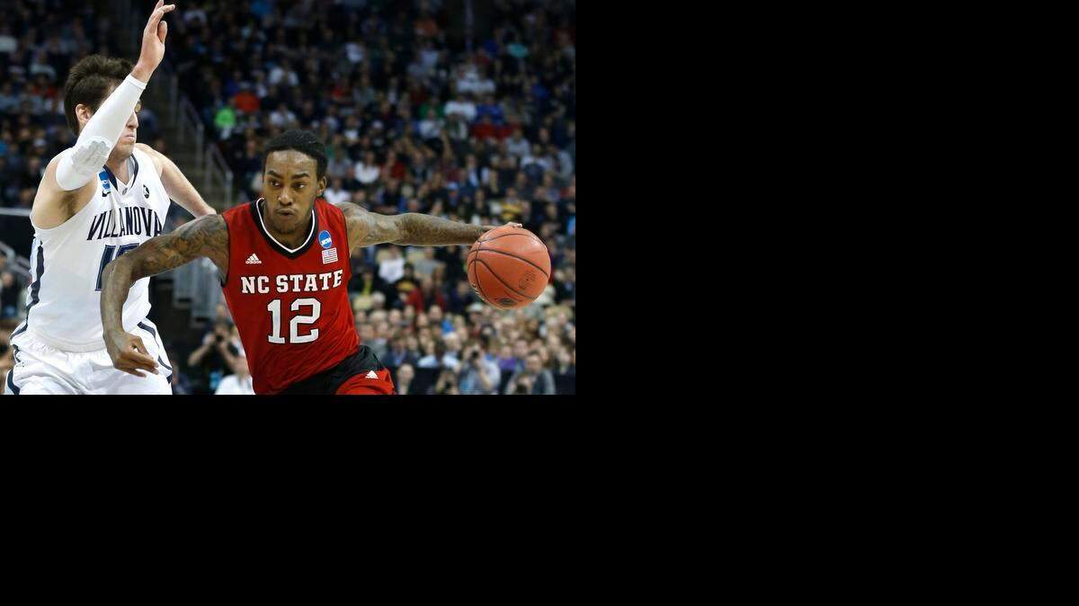 
N.C. State's Cat Barber (12) drives around Villanova's Ryan Arcidiacono (15) during the first half of the Wolfpack's game against Villanova.
