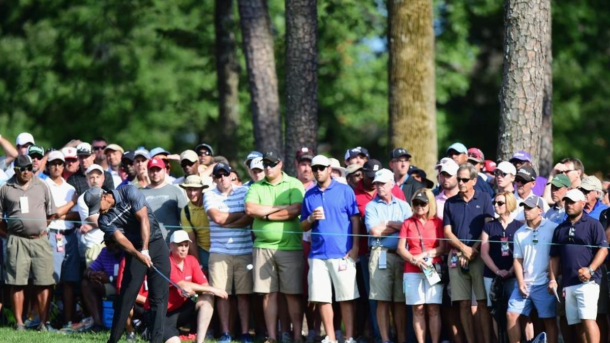 
Tiger Woods plays his second shot from the rough on the 18th hole during the second round of the Wyndham Championship at Sedgefield Country Club on Friday in Greensboro.
