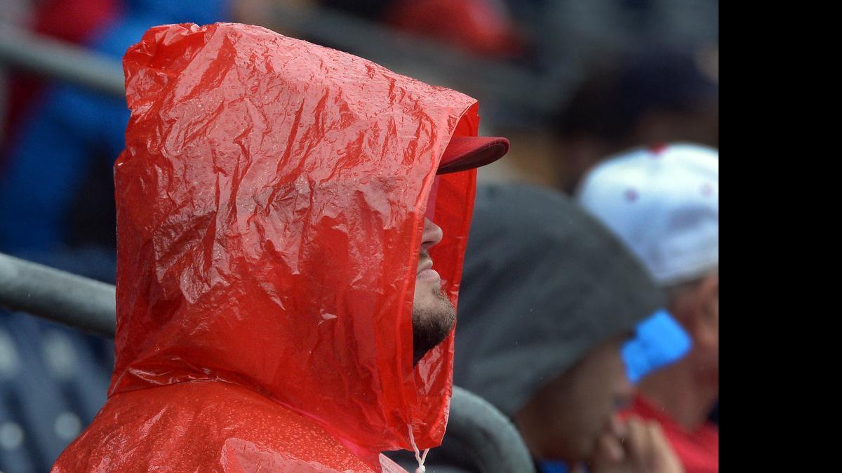 
NC State baseball fan Chris Hathcock doesn't let a little rain bother him as he watches the Wolfpack play Notre Dame at the Durham Bulls Athletic Park in Durham, Thursday, May 21, 2015 during the ACC Baseball Tournament.
