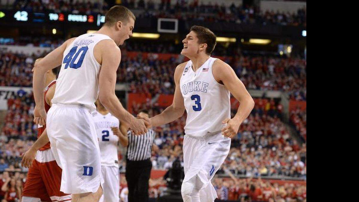 
Duke's Marshall Plumlee (40), left, celebrates with Duke's Grayson Allen (3) during the second halfagainst Wisconsin in the 2015 Division I Men's Basketball Championship game at Lucas Oil Stadium in Indianapolis.
