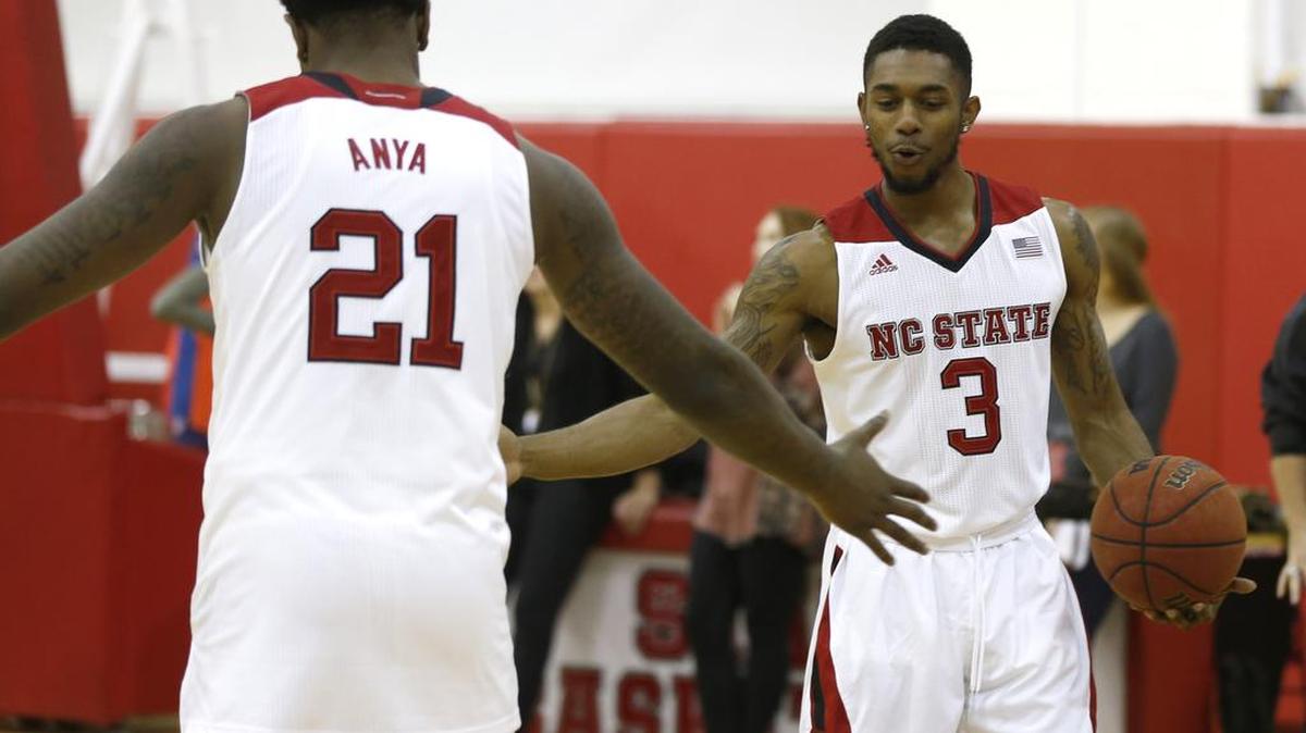 
N.C. State's Terry Henderson (3), right, high-fives BeeJay Anya (21) while shooting the ball before the N.C. State basketball media day at Dail Basketball Center in Raleigh on Thursday., N.C. Thursday, Oct. 1, 2015.
