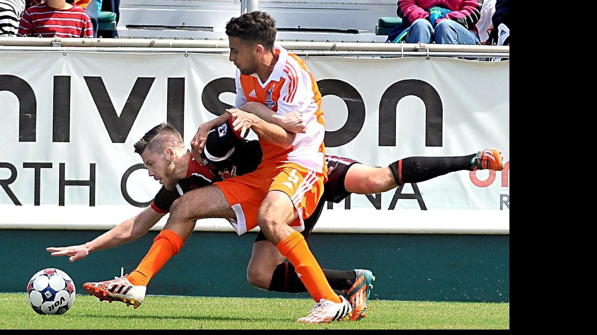 
The Carolina RailHawks' Nazmi Albadawi (5) and Ottawa Fury's Carl Haworth (17) battle for control of the ball in the RailHawks' season opener at the WakeMed Soccer Park in Cary, N.C. on April 4, 2015.
