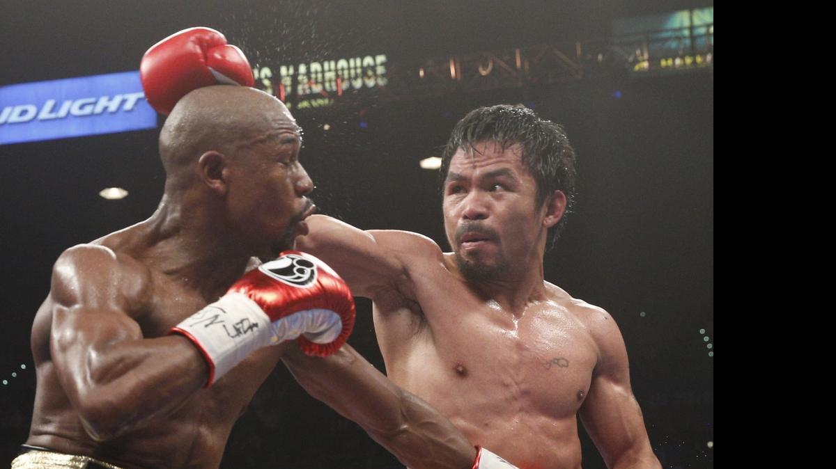 
Floyd Mayweather Jr.,, left, and Manny Pacquiao fight during their welterweight unification boxing bout Saturday night.
