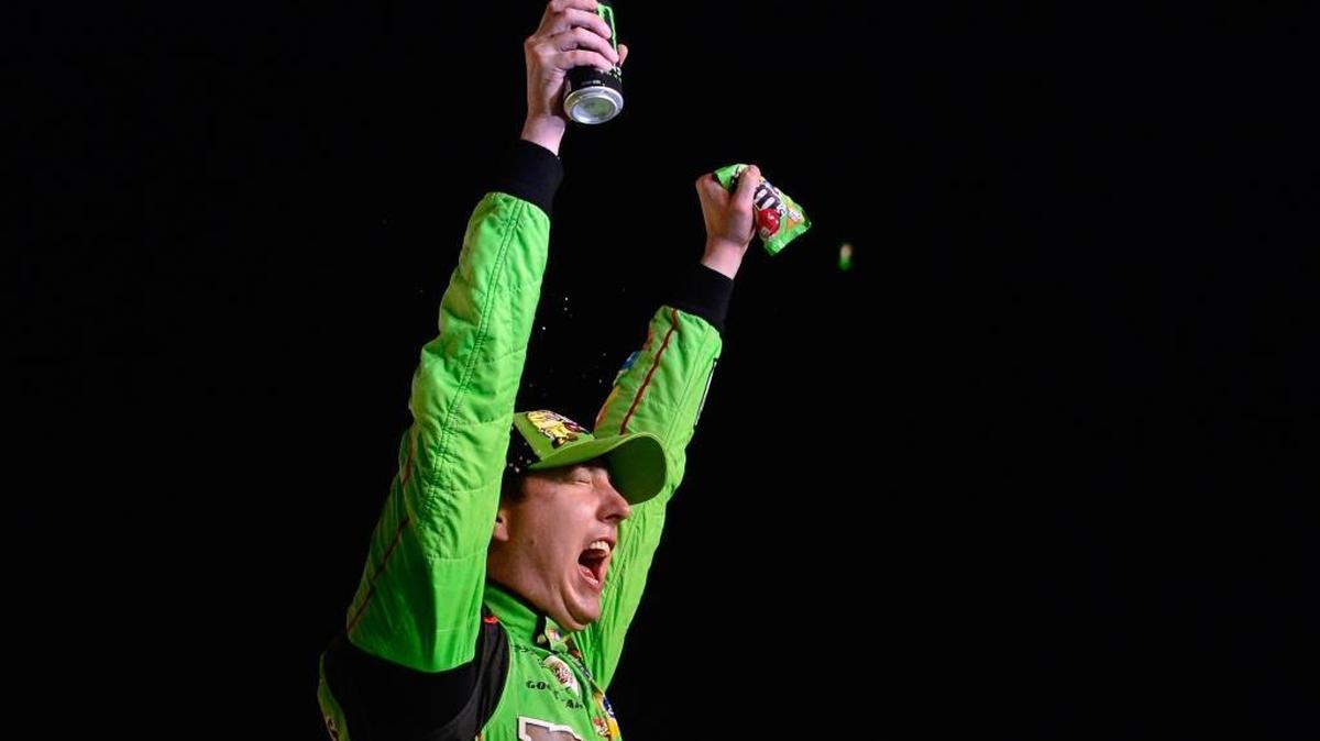 Kyle Busch celebrates winning the Sprint Cup series championship in Victory Lane after Sunday’s NASCAR Sprint Cup Series Ford EcoBoost 400 at Homestead-Miami Speedway.