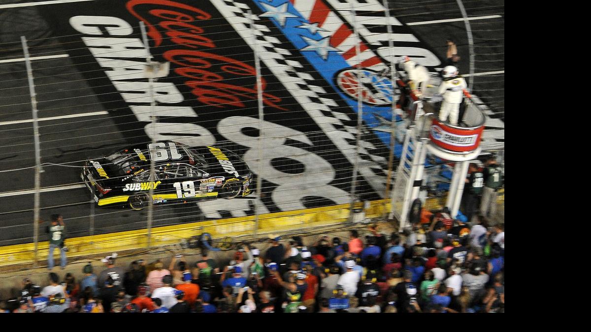 
NASCAR Sprint Cup Series driver Carl Edwards crosses the finish line to win the Coca-Cola 600 at Charlotte Motor Speedway on Sunday, May 24, 2015.
