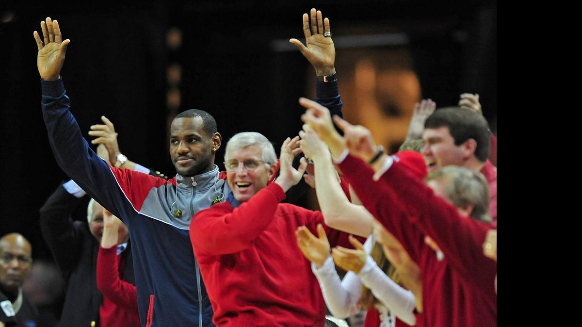 
NBA star Lebron James of the Cleveland Cavaliers signals a 3-pointer by Davidson Wildcats guard Stephen Curry as fans celebrate during the second half of a victory over N.C. State at Time Warner Cable Arena in Charlotte in 2008. Curry scored 44 points that day. 
