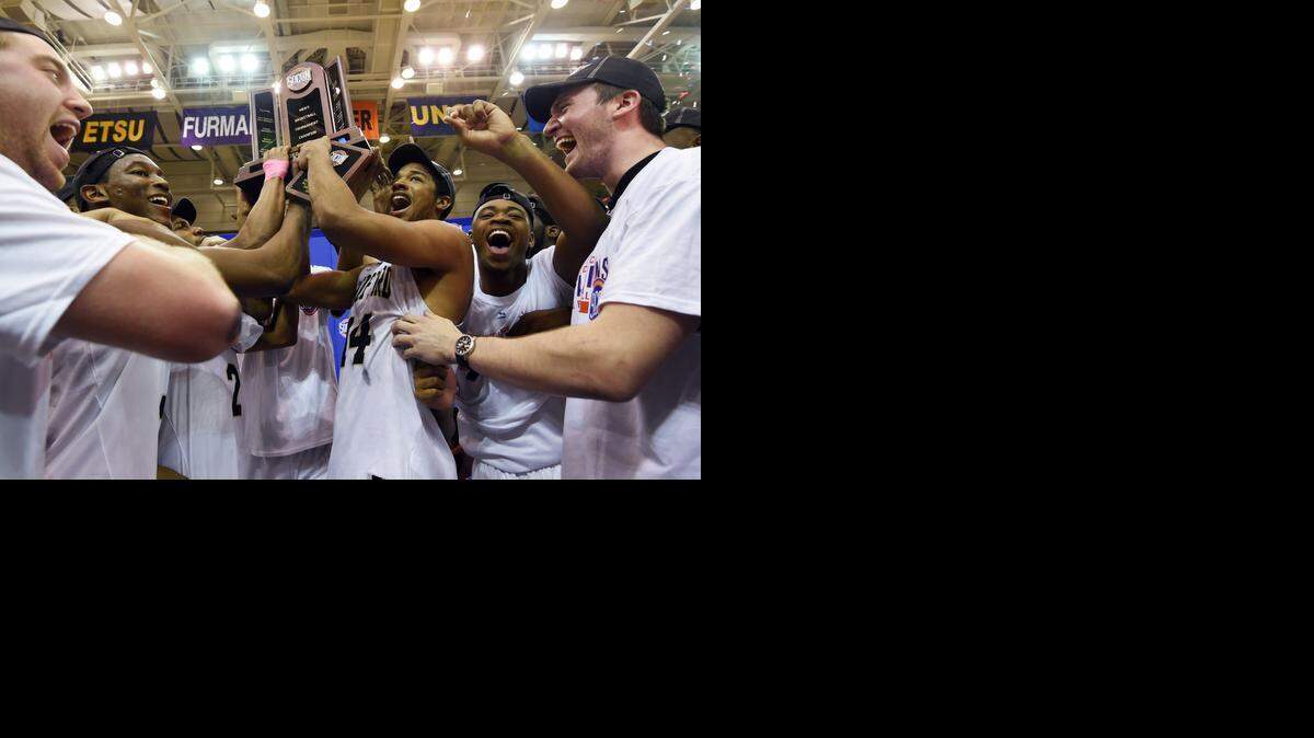 
Wofford players celebrate while holding the trophy after defeating Furman 67-64 to win the Southern Conference tournament March 9. The Terriers, a 12 seed, will play fifth-seeded Arkansas on Thursday at 9:50 p.m. The game will be broadcast on TNT.
