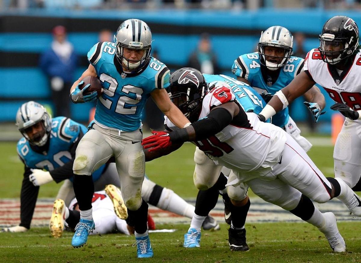 Carolina Panthers running back Christian McCaffrey, left, breaks free for yardage against Atlanta in November. The Panthers won, 20-17, and face the Falcons again in Atlanta on Dec. 31st in a game that will almost certainly carry playoff implications.