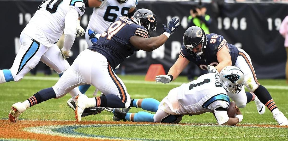 Carolina Panthers quarterback Cam Newton (1) goes down as Chicago Bears defensive end Mitch Unrein (98) and nose tackle Eddie Goldman (91) converge on him Sunday.