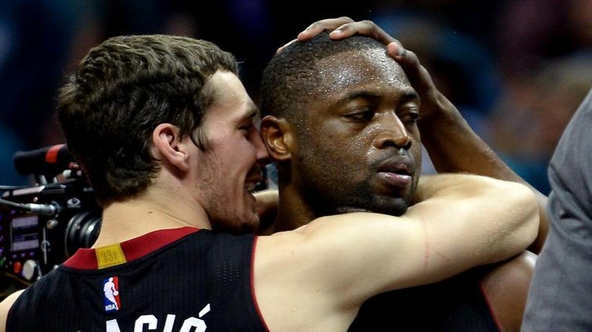 Miami Heat guard Goran Dragic, embraces Dwyane Wade after Wade hit a key shot and blocked a shot by Charlotte Hornets guard Kemba Walker inside the final minute.
