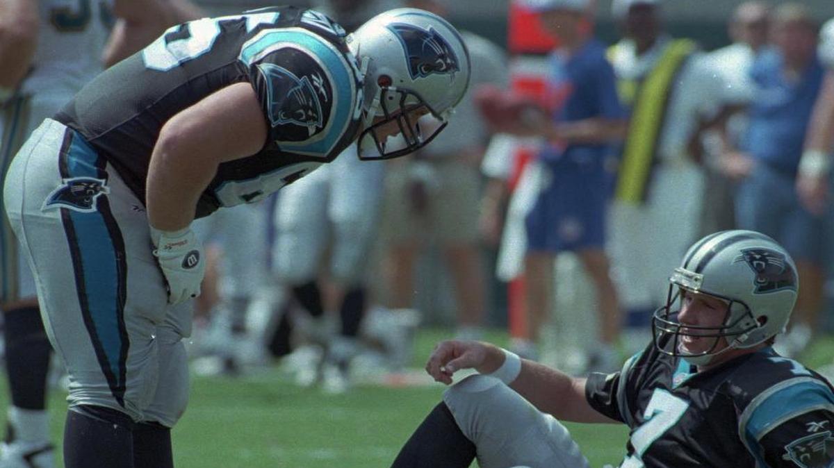 
In this 1996 Observer file photo, Panthers center Frank Garcia checks on quarterback Steve Beuerlein after Beuerlein got sacked in a game against Jacksonville. Garcia says there is no worse feeling in sports than having to help your quarterback up after allowing him to get sacked. 
