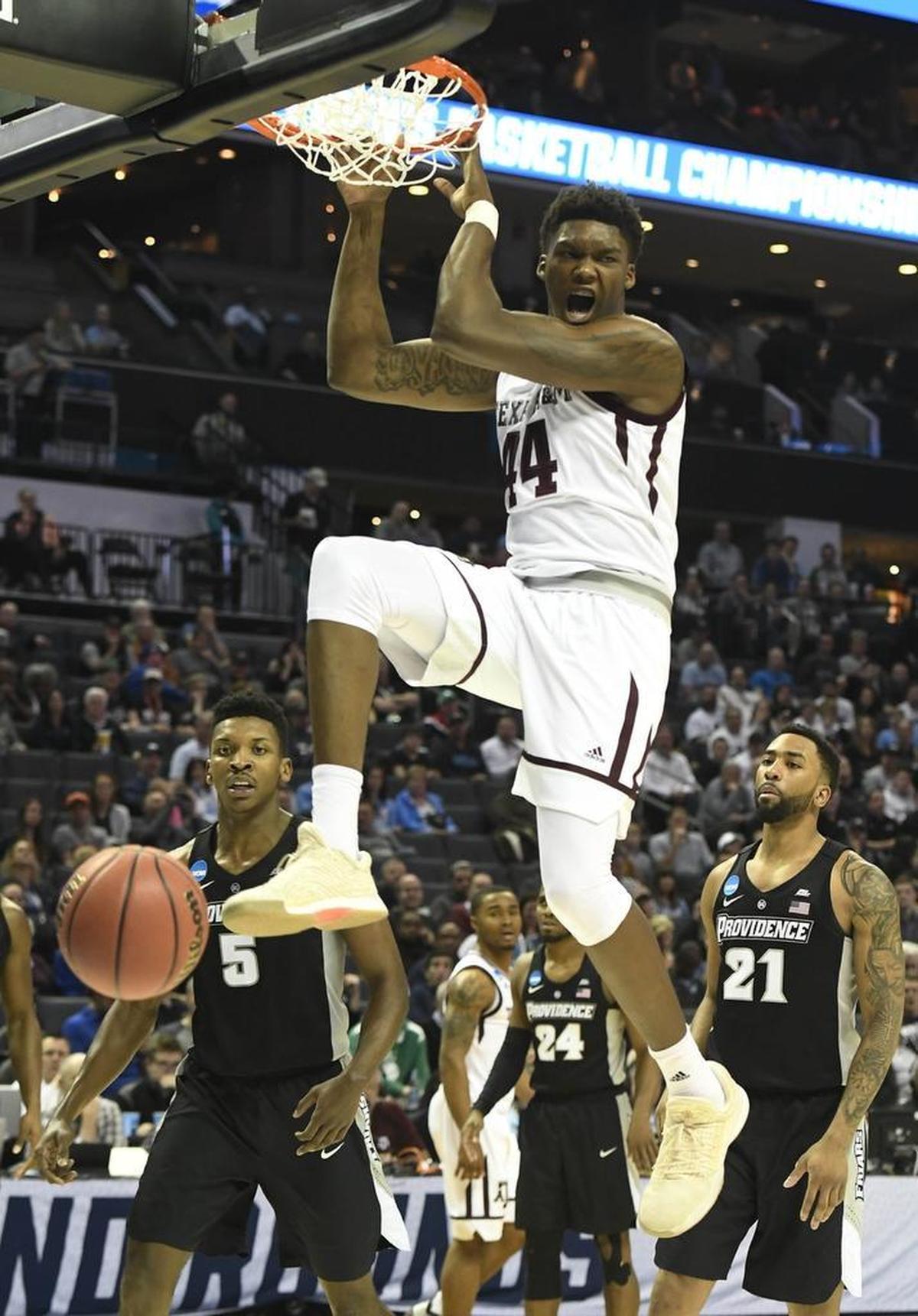 Texas A&M’s Robert Williams reacts after his dunk against Providence Friday. Williams will be one of the keys for the Aggies as they try to pull an upset against North Carolina Sunday in Charlotte.