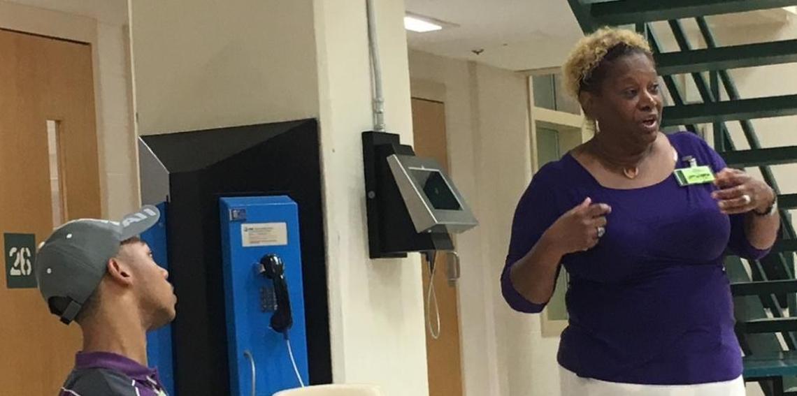 Saundra Adams speaks to inmates at the Mecklenburg County Jail in October 2017 as her grandson Chancellor Lee Adams looks on. Her 30-minute talk received a standing ovation from several of the prisoners, who also had questions about how she had been able to forgive Rae Carruth and his three co-conspirators for murdering her daughter.