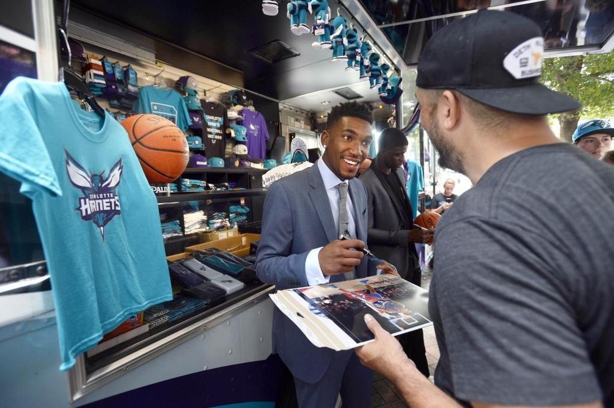 Charlotte Hornets 2017 draft pick Malik Monk signs an autograph while he and fellow draft pick Dwayne Bacon greet fans in uptown Charlotte on Friday.