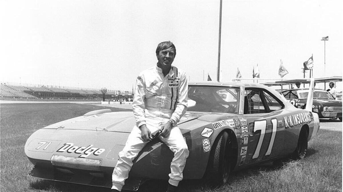 In 1970, Bobby Isaac poses with Nord Krauskoph’s K&K Insurance Dodge Charger Daytona at Daytona International Speedway.