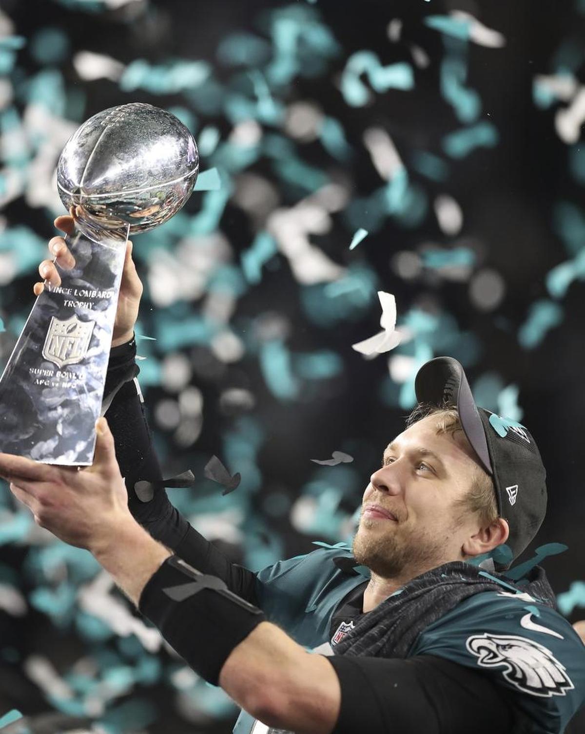 As confetti floats down at U.S. Bank Stadium, Philadelphia Eagles quarterback Nick Foles lifts up the Vince Lombardi trophy after leading his team to a 41-33 victory over the New England Patriots in Super Bowl LII. Foles not only threw for 373 yards but also caught a one-yard, fourth-down touchdown pass in the second quarter.