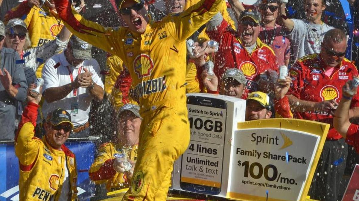 
Joey Logano, driver of the Shell Pennzoil Ford celebrates in victory lane after winning the NASCAR Sprint Cup Bank of America 500 at Charlotte Motor Speedway, Sunday, October 11, 2015. 
