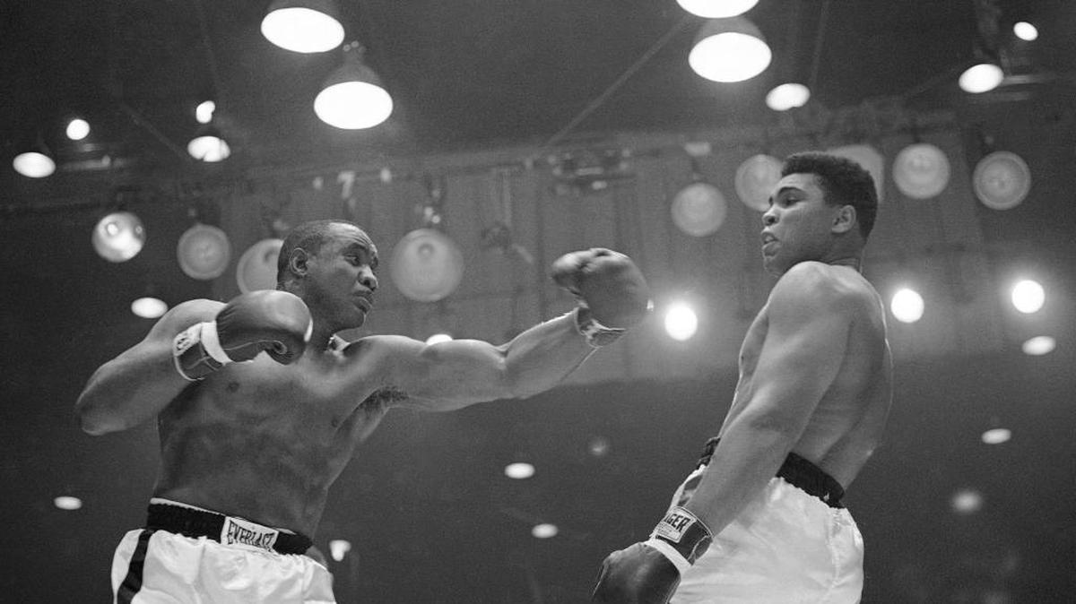 On Feb. 25, 1964, the boxer then known as Cassius Clay (right) bobbed and weaved away from Sonny Liston before winning the heavyweight championship in their title fight in Miami Beach, Fla. Clay had met with Paul Silas and his Creighton basketball teammates about two weeks prior to the fight and expressed private doubts as to whether he would win it. Ali died Friday at age 74.