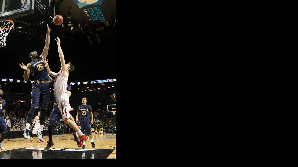 
Davidson’s Tyler Kalinoski releases his game-winning shot in Friday’s victory over La Salle in the Atlantic 10 quarterfinals in Brooklyn. 
