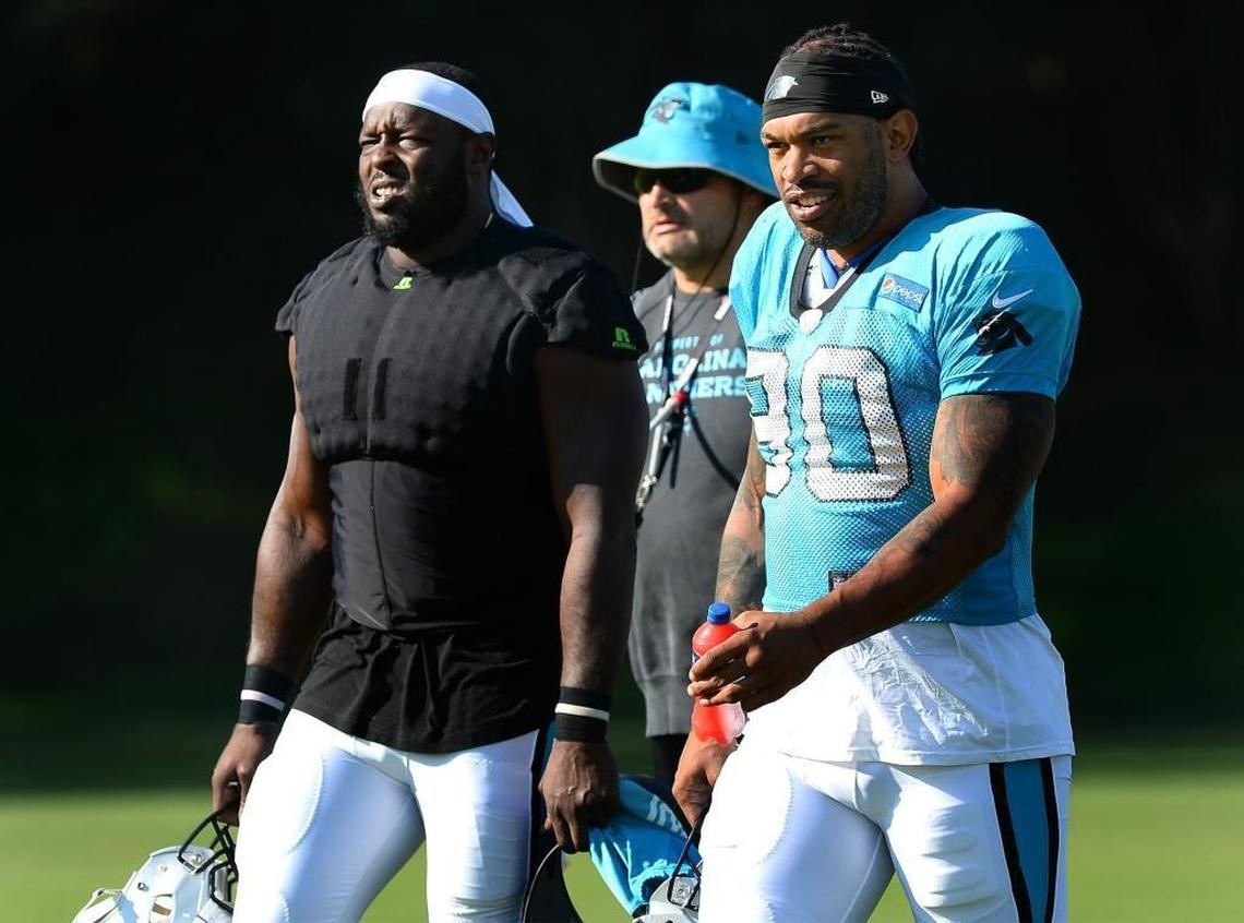 Carolina Panthers defensive ends Charles Johnson (left) and Julius Peppers walk to practice Tuesday. Peppers and Johnson, who teamed together for three years in the late 2000s, rank 1-2 on the Panthers’ all-time sack list.