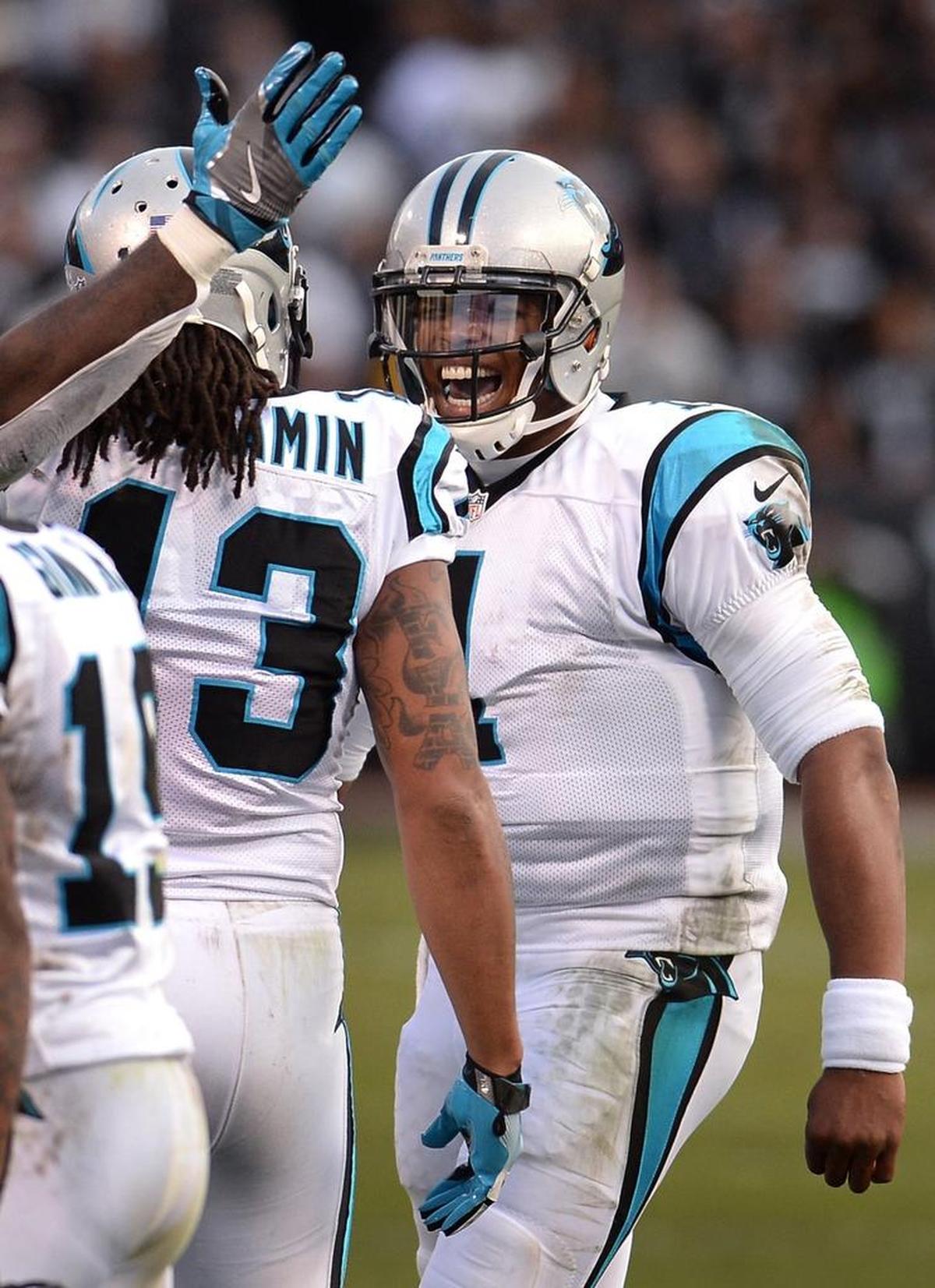 Carolina Panthers quarterback Cam Newton, right, congratulates Kelvin Benjamin after a touchdown in 2016. Newton has already surpassed Jake Delhomme in both rushing and passing TDs.