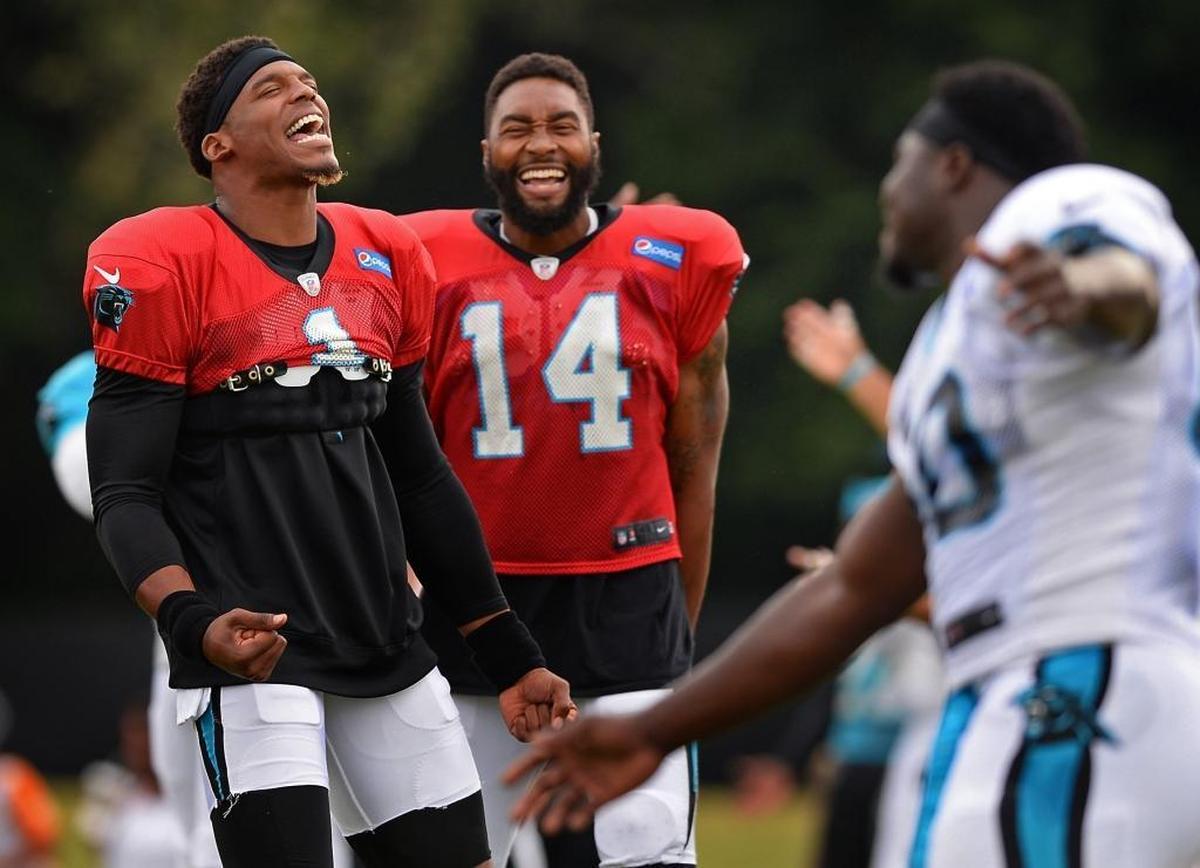 Carolina Panthers quarterback Cam Newton, left, entertains teammates including quarterback Joe Webb (14) during a pre-practice stretching session on Aug. 2.