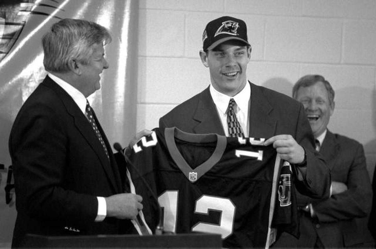 There were smiles all around the day in 1995 that Carolina Panthers owner Jerry Richardson, left, handed first-ever draft pick Kerry Collins his first jersey after Carolina general manager Bill Polian (right) took Collins with the Panthers’ first-ever draft choice. Christopher A. Record/Staff