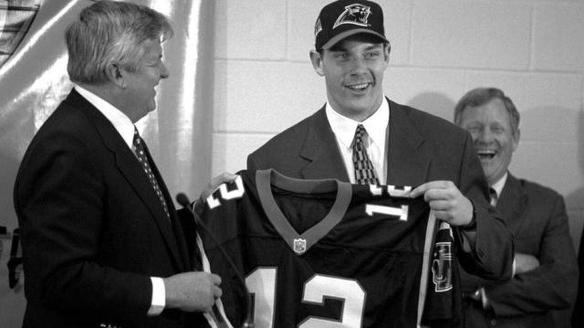 
There were smiles all around the day in 1995 that Carolina Panthers owner Jerry Richardson, left, handed first-ever draft pick Kerry Collins his first jersey after Carolina general manager Bill Polian (right) took Collins with the Panthers’ first-ever draft choice. Christopher A. Record/Staff
