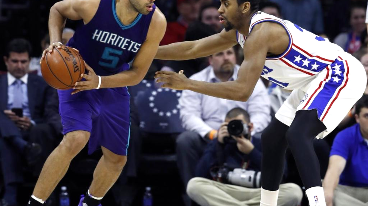 Charlotte Hornets' Nicolas Batum, left, tries to dribble past Philadelphia 76ers' Hollis Thompson during the second half of an NBA basketball game, Tuesday, March 29, 2016, in Philadelphia. Charlotte won 100-85.