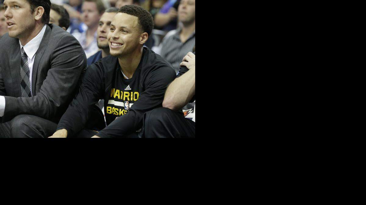 
Golden State’s Stephen Curry, a former Davidson star, smiles from the bench in April during the Warriors’ 12th straight victory.
