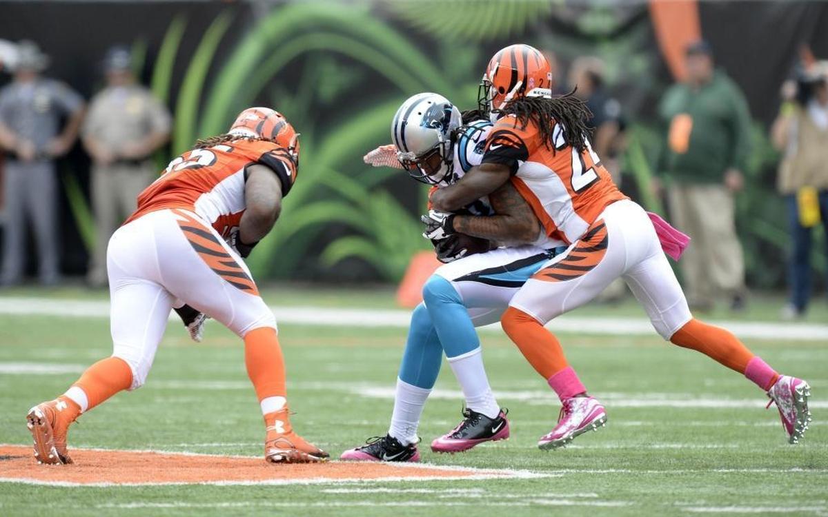 On this play in 2014, Carolina’s Kelvin Benjamin (13) cradled the ball as he was being tackled and braced for a high hit from Vontaze Burfict (55, on left). Benjamin suffered a concussion on the play. Burfict, a repeat offender of NFL safety rules, is going to be suspended for the first five games of the 2017 NFL season. He plans to appeal.