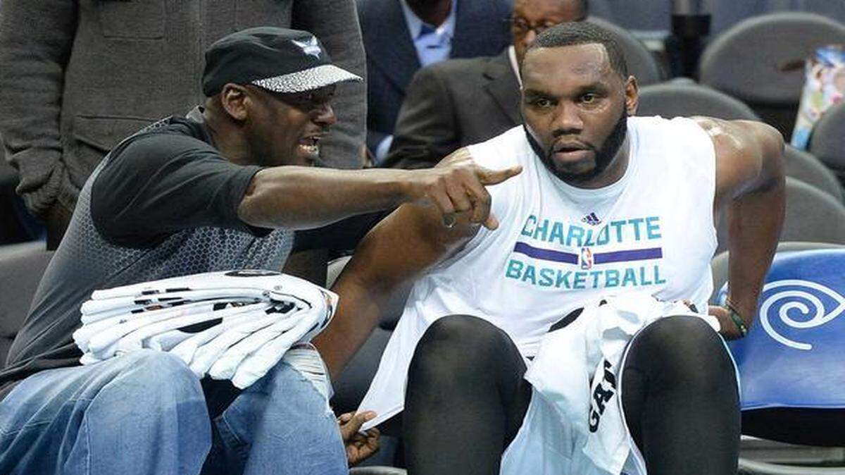 
 Charlotte Hornets owner Michael Jordan, left, gives instructions from the bench to Al Jefferson, right, during Wednesday night's game at Time Warner Cable Arena. The Brooklyn Nets defeated the Charlotte Hornets 91-88.
