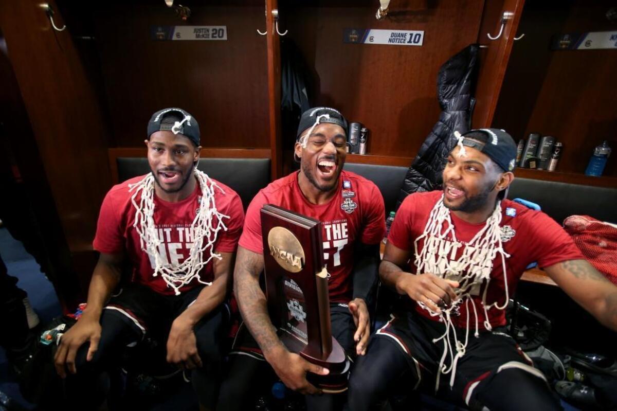 South Carolina Gamecocks senior guards Justin McKie (20), Duane Notice (10) and Sindarius Thornwell (0) celebrate with the NCAA regional trophy after beating Florida in New York.