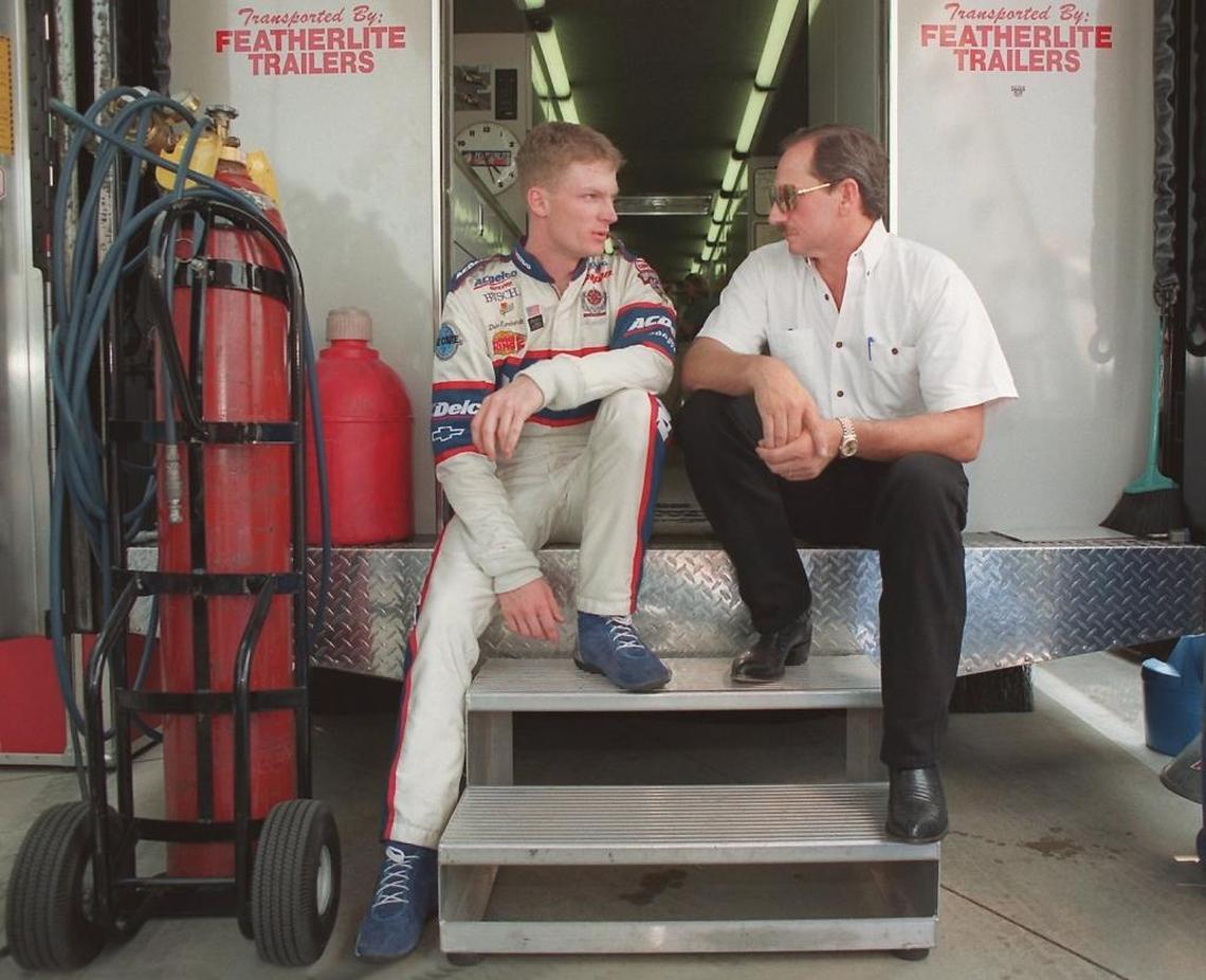 Dale Earnhardt Jr. (left) and his father, Dale Earnhardt Sr., talk in Charlotte in 1998.