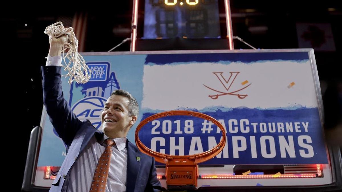 Virginia head coach Tony Bennett holds up the net after defeating North Carolina in the championship game of the ACC tournament Saturday. Virginia is the overall No. 1 seed in the NCAA tournament and is trying to reach the Final Four for the first time since 1984.