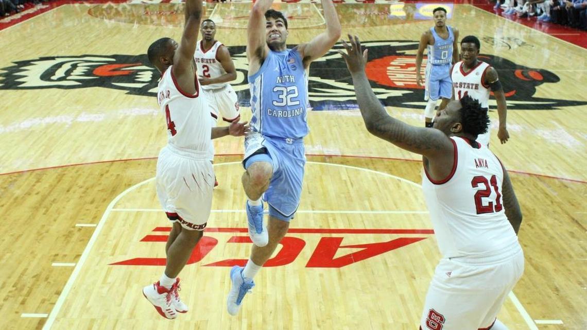 North Carolina sophomore Luke Maye (32) drives to the basket between N.C. State's Dennis Smith Jr. (left) and BeeJay Anya (right) during the Tar Heels’ 97-73 victory over N.C. State last week in Raleigh. Maye scored a career-high 13 points in the game.