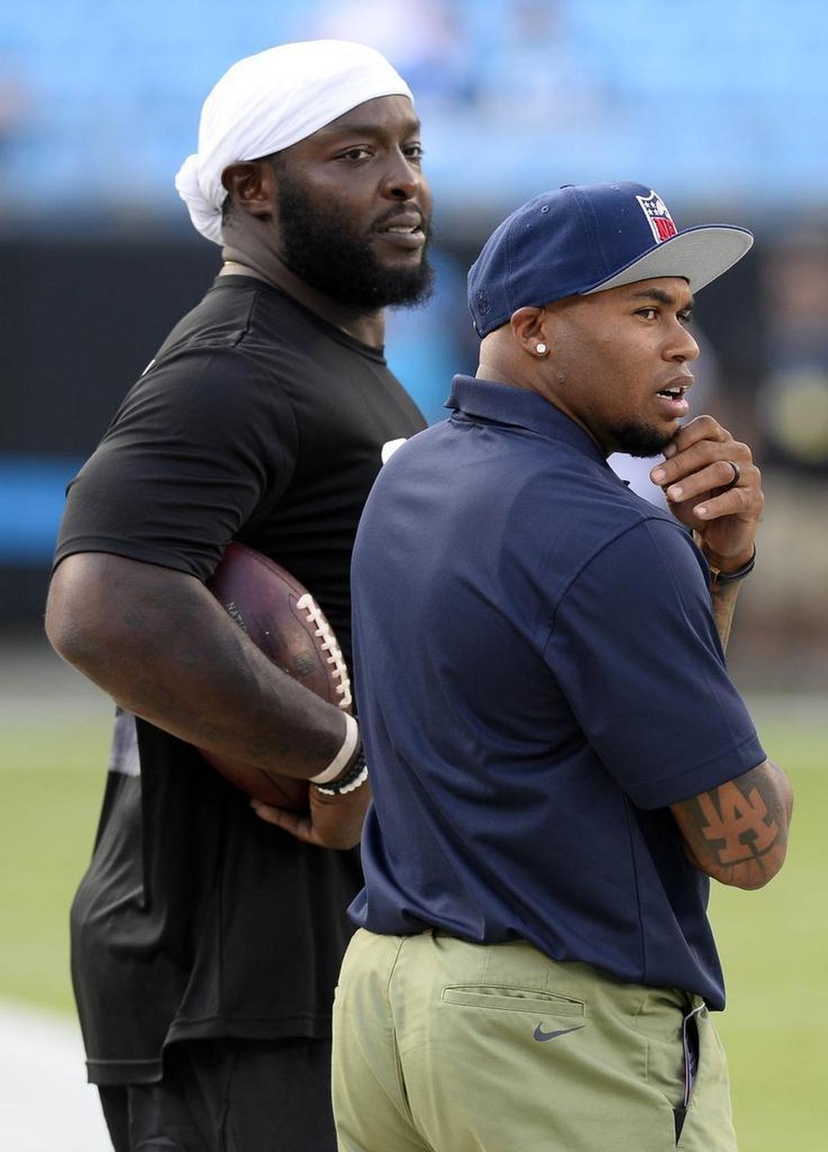 Former Carolina Panthers receiver Steve Smith, on right, expects that rookie running back Christian McCaffrey is “going to have a fantastic year and he’s going to be one of the guys up for Rookie of the Year.” Above, Smith, working for NFL Network, watches warmups with defensive end Charles Johnson, left.