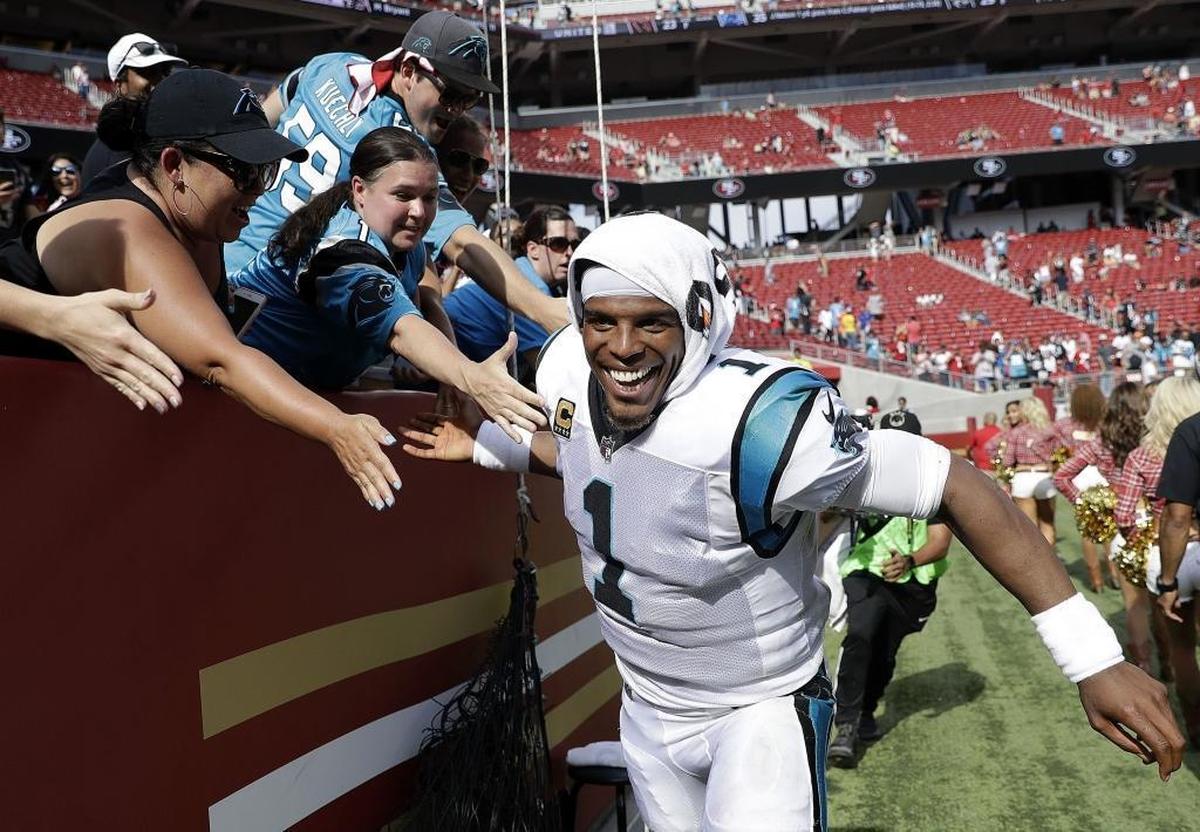 Carolina Panthers quarterback Cam Newton celebrates with fans after the Panthers beat the San Francisco 49ers, 23-3, Sunday. Newton threw two touchdown passes in the win.