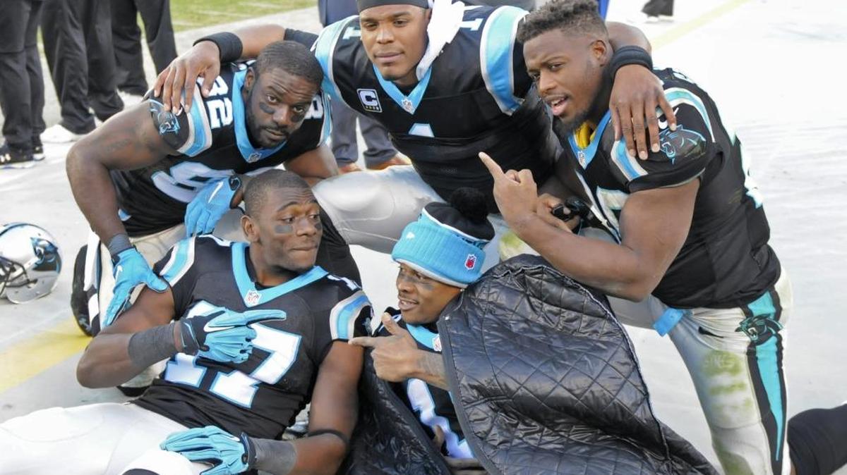 Carolina Panthers players, clockwise from bottom left, Devin Funchess, Jerricho Cotchery, Cam Newton, Jonathan Stewart, and Ted Ginn, celebrate on the sideline in the second half of an NFL football game against the Washington Redskins in Charlotte, N.C., Sunday, Nov. 22, 2015. The Panthers won 44-16.