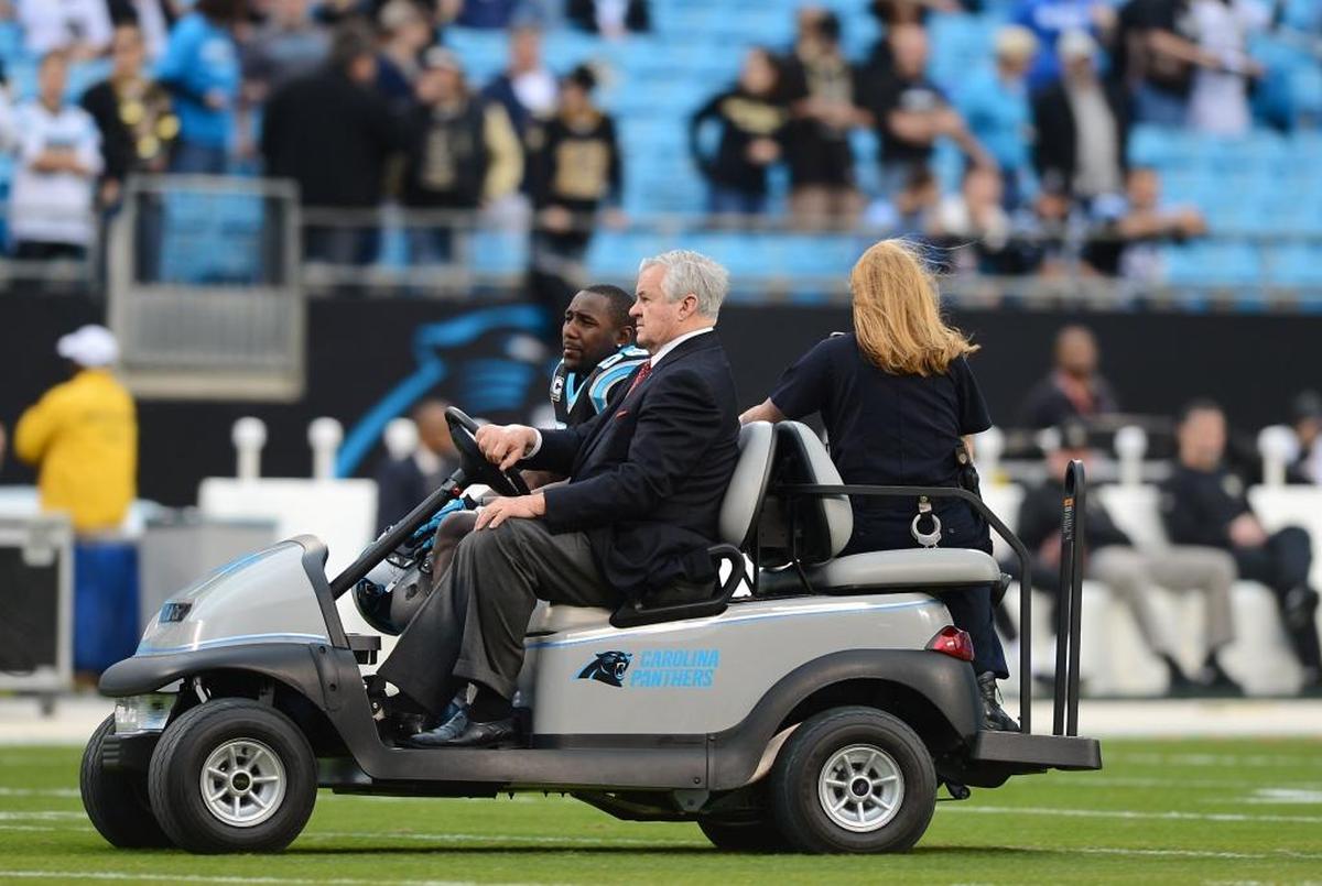 Carolina Panthers owner Jerry Richardson drives Thomas Davis in a golf cart prior to a 2013 game. Richardson and Davis have maintained a close bond for more than a decade.