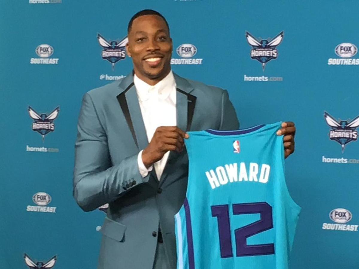 Dwight Howard posed with his new No. 12 Charlotte Hornets jersey at a press conference in late June announcing his trade to the team. Howard said at the press conference there were now “two supermen” in Charlotte, referring to himself and Cam Newton.
