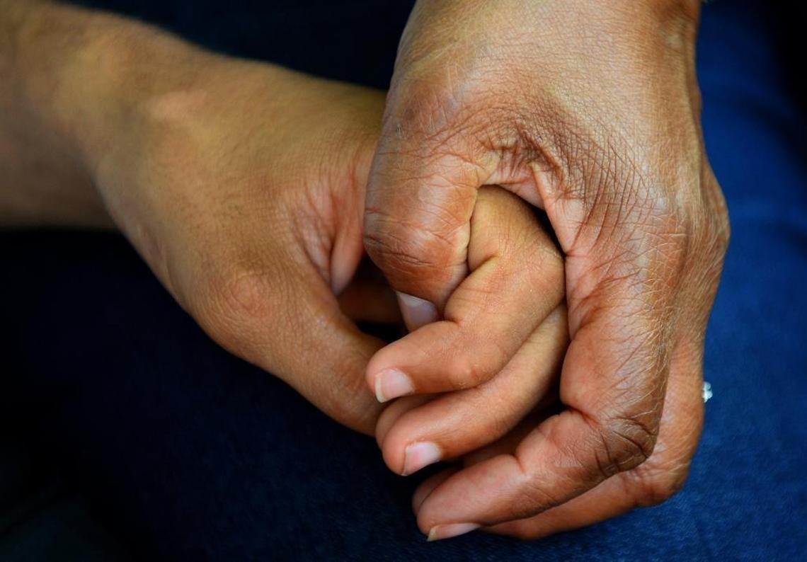 Saundra Adams holds the hand of her grandson, Chancellor Lee Adams. The two of them plan to meet Chancellor Lee’s father, Rae Carruth, at the prison gates when he is released in 2018.