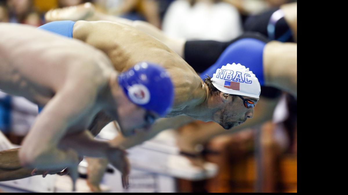 
Michael Phelps dives in at the start of the 100-meter butterfly final at the Arena Pro Swim Series meet in Charlotte, Friday, May 15, 2015. Phelps finished in third place.

